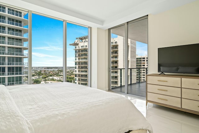 bedroom with a wall of windows and access to outside