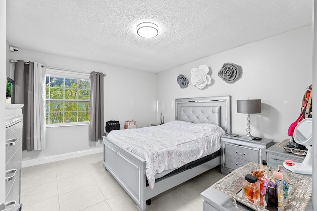 tiled bedroom featuring a textured ceiling