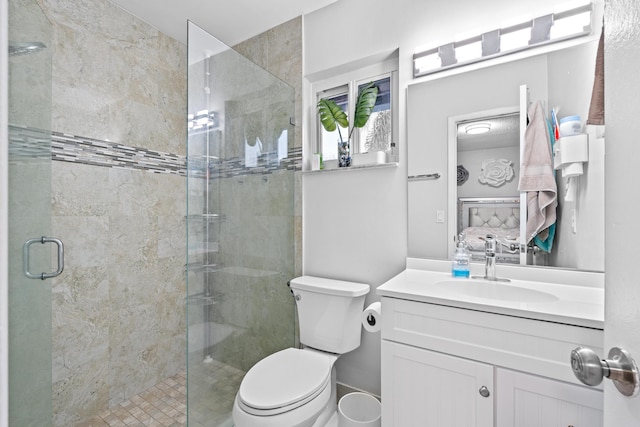 bathroom with an enclosed shower, vanity, and toilet