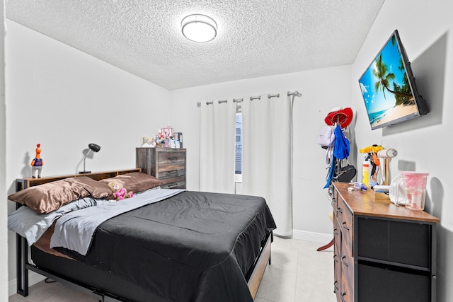 tiled bedroom featuring a textured ceiling