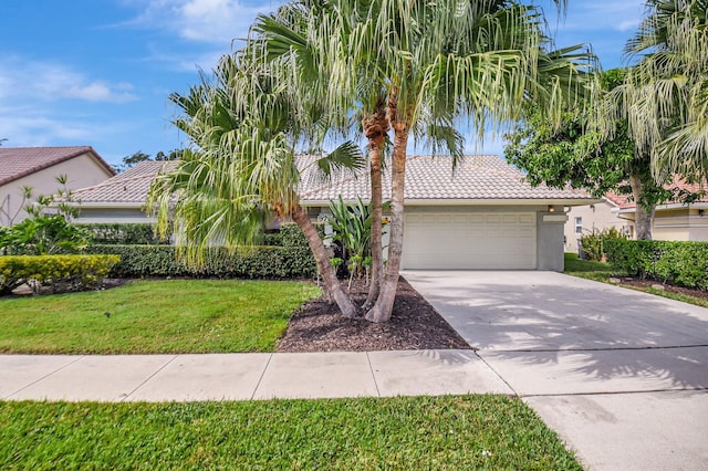 view of front of property featuring a garage and a front lawn