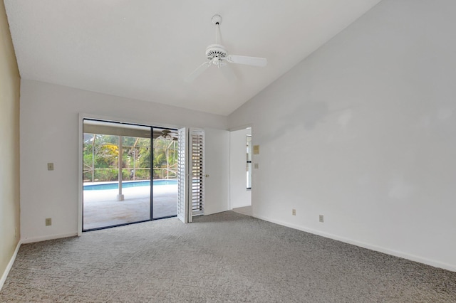 carpeted empty room with ceiling fan and high vaulted ceiling