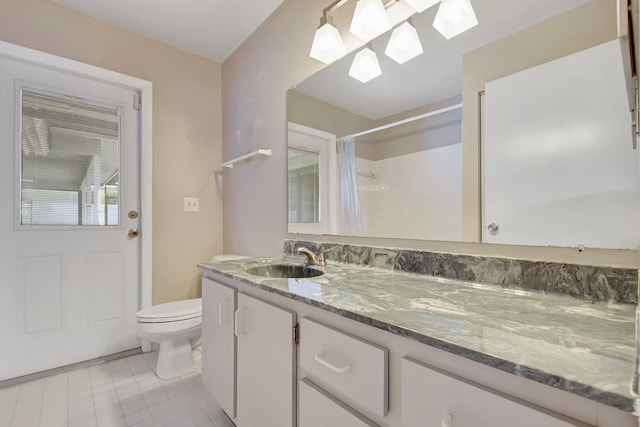 bathroom featuring vanity, tile patterned flooring, toilet, and walk in shower