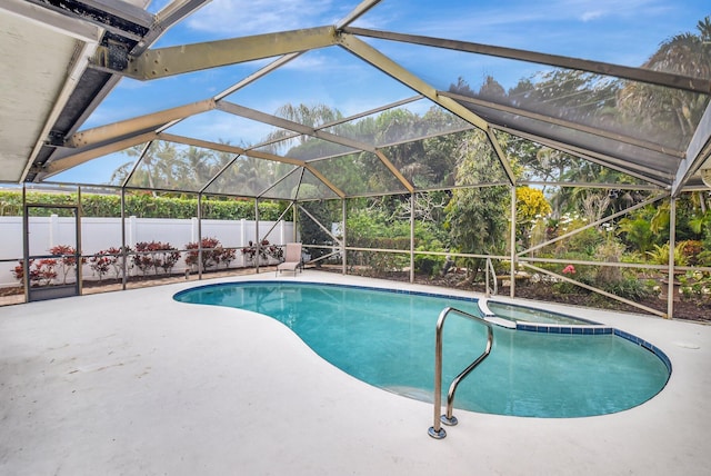 view of swimming pool with a patio area and glass enclosure