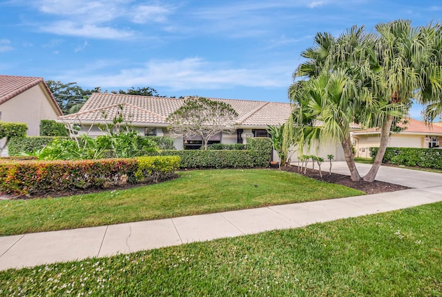 mediterranean / spanish house with a front yard