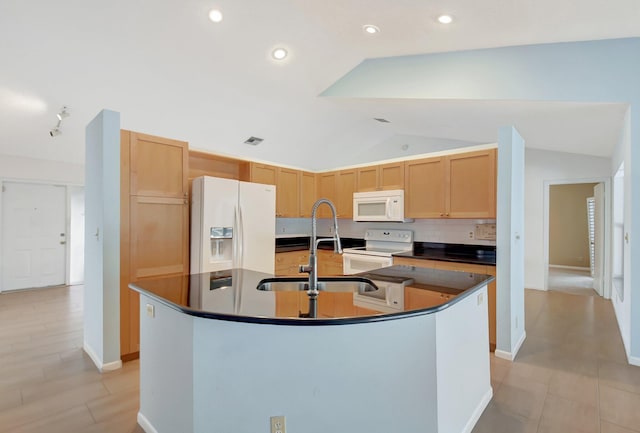 kitchen with lofted ceiling, sink, tasteful backsplash, white appliances, and a kitchen island with sink