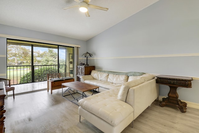 living room with ceiling fan, lofted ceiling, and light hardwood / wood-style flooring