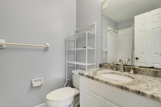 bathroom featuring vanity, curtained shower, and toilet