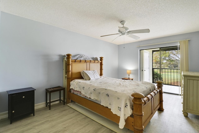 bedroom featuring ceiling fan, access to outside, light hardwood / wood-style floors, and a textured ceiling