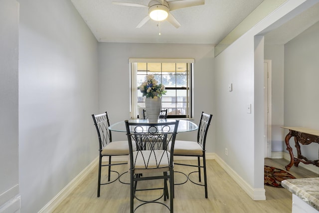 dining area featuring ceiling fan and light hardwood / wood-style flooring