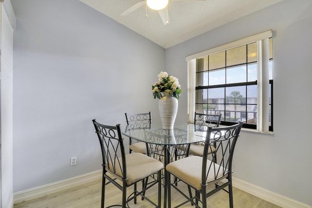 dining room featuring ceiling fan, lofted ceiling, and light hardwood / wood-style floors