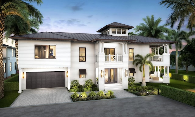 view of front facade featuring a balcony and a garage