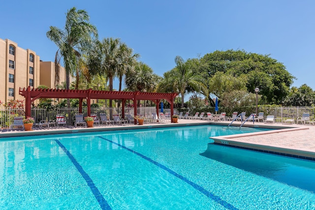 view of swimming pool with a patio and a pergola