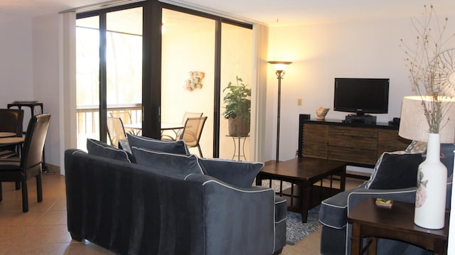 tiled living room featuring a wall of windows