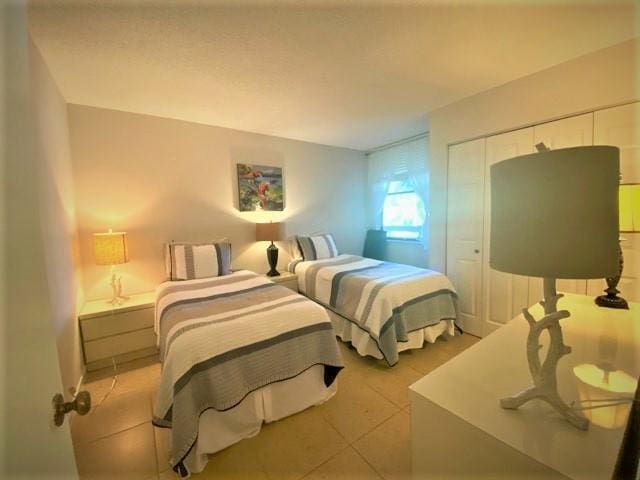 tiled bedroom featuring a closet