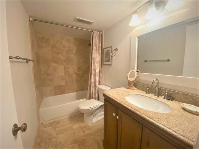 full bathroom with shower / bath combo, vanity, and toilet