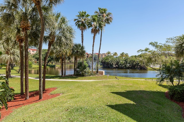 surrounding community featuring a lawn and a water view