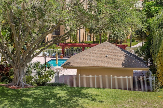 exterior space featuring a pergola and a lawn