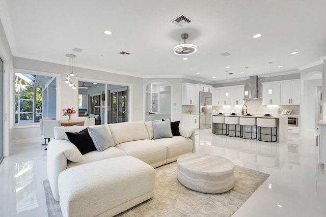 living room with sink and ornamental molding