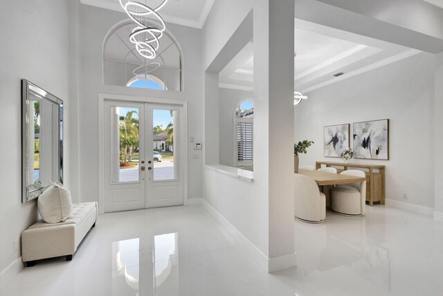 11960 Torreyanna Cir, West Palm Beach, FL 33412 - tiled foyer featuring ornamental molding, french doors, a chandelier, and baseboards