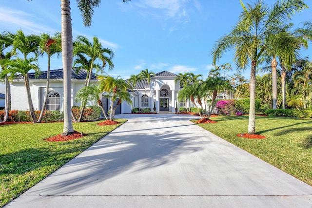 mediterranean / spanish-style home with a front lawn