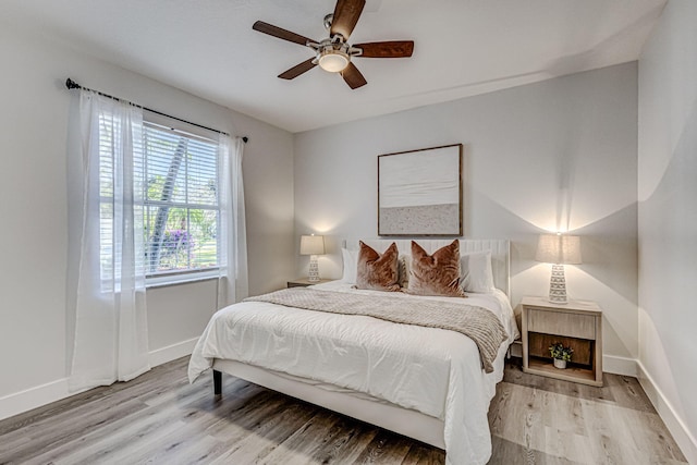 bedroom with ceiling fan and wood-type flooring