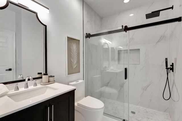 bathroom with toilet, a shower with shower door, and vanity