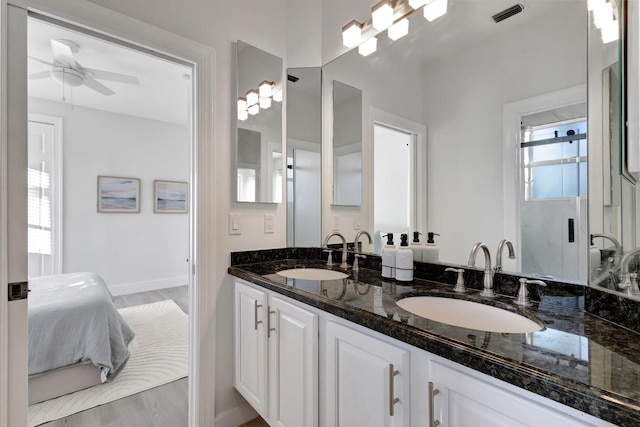 bathroom featuring wood-type flooring, ceiling fan, vanity, and a shower with door