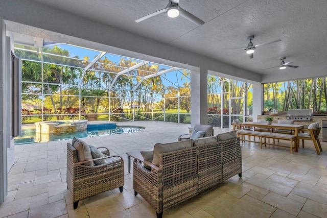 view of patio featuring grilling area, a lanai, an outdoor kitchen, ceiling fan, and an outdoor living space