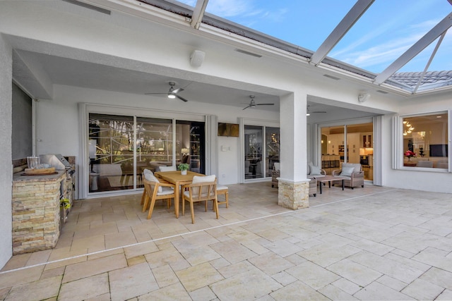 view of patio / terrace with a lanai and ceiling fan