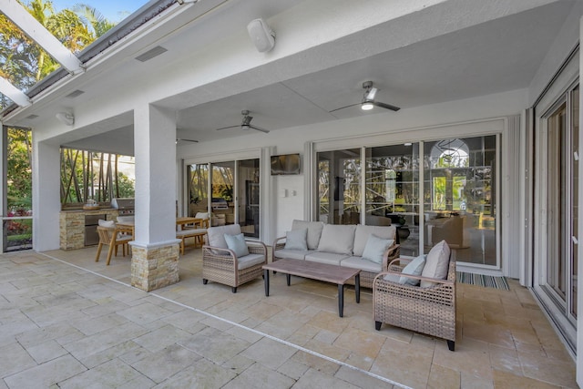 view of patio / terrace featuring an outdoor living space, exterior kitchen, and ceiling fan