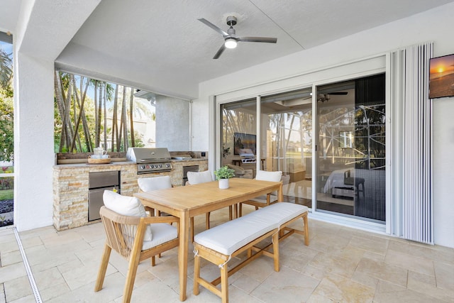 view of patio with a grill, ceiling fan, and exterior kitchen