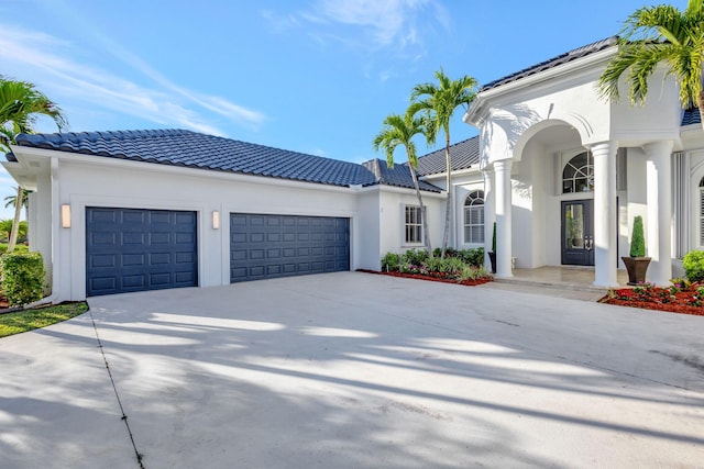 mediterranean / spanish-style home with a garage