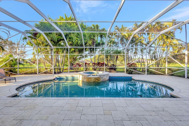 view of pool with a patio area, an in ground hot tub, and glass enclosure