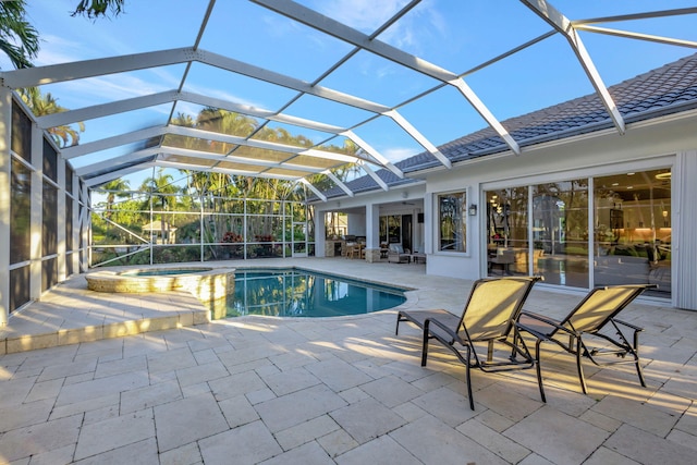 view of pool featuring an in ground hot tub, a lanai, and a patio area