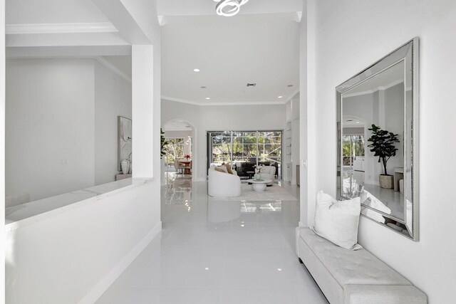 11960 Torreyanna Cir, West Palm Beach, FL 33412 - hallway featuring arched walkways, tile patterned flooring, recessed lighting, baseboards, and crown molding