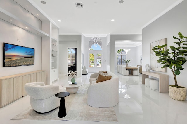 living room featuring built in features, french doors, and crown molding