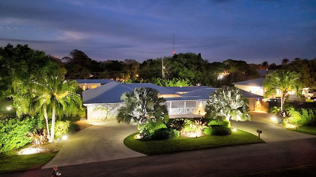 view of front of home featuring driveway and metal roof