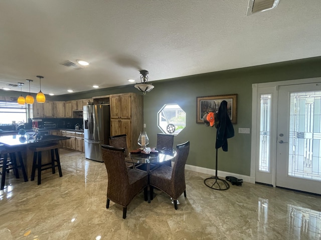 dining space with a textured ceiling