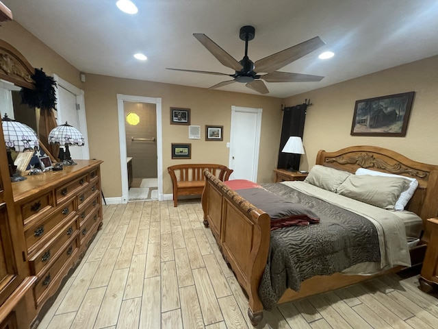 bedroom featuring ceiling fan, connected bathroom, and light hardwood / wood-style flooring