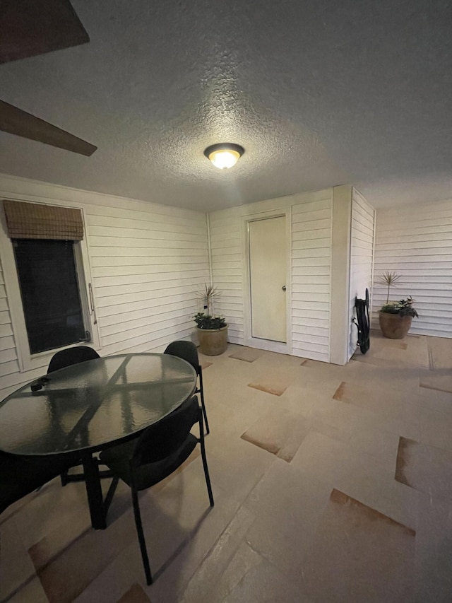 dining room featuring a textured ceiling