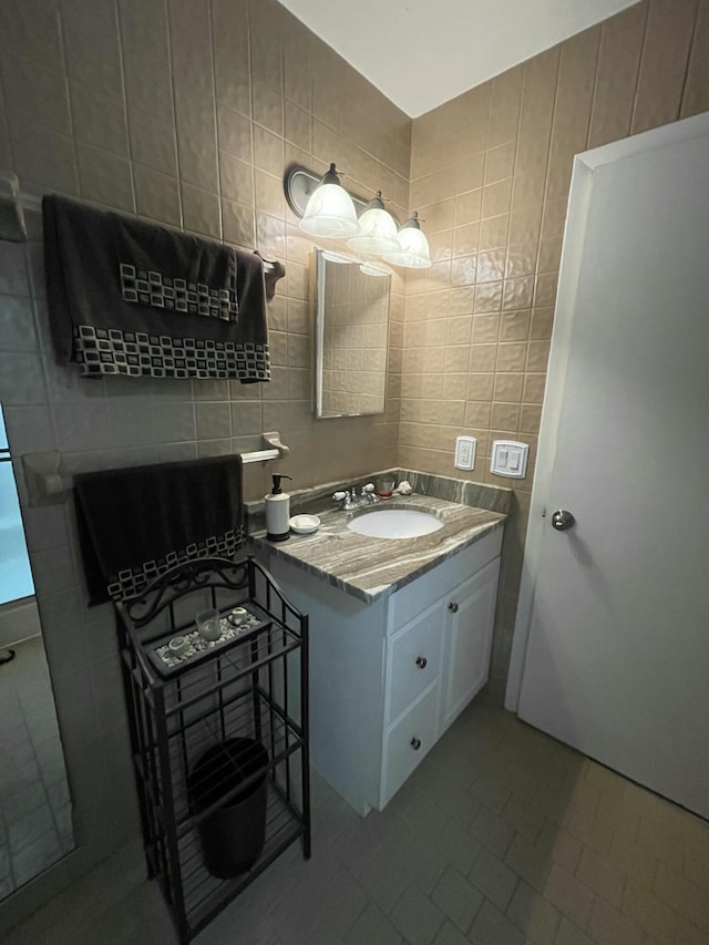 bathroom featuring tile walls and vanity