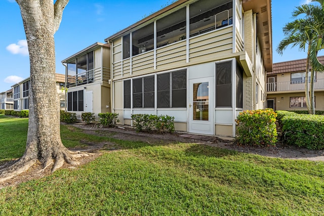 rear view of property featuring a yard