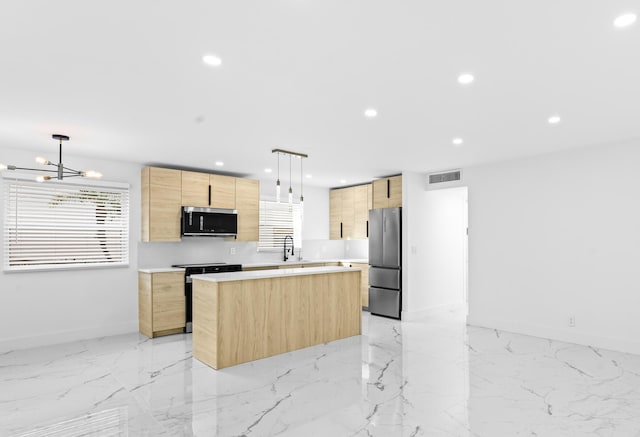 kitchen with appliances with stainless steel finishes, light brown cabinetry, decorative light fixtures, sink, and a center island