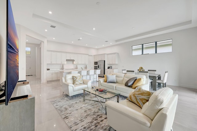 living room with a tray ceiling