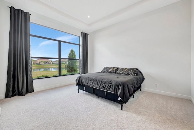 carpeted bedroom featuring a water view