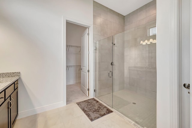 bathroom with vanity, tile patterned floors, and walk in shower