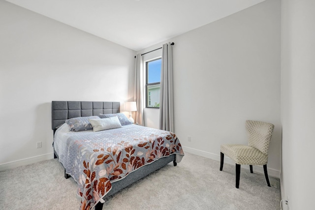 carpeted bedroom with lofted ceiling