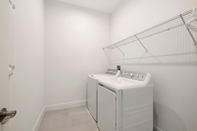 clothes washing area featuring washer and clothes dryer