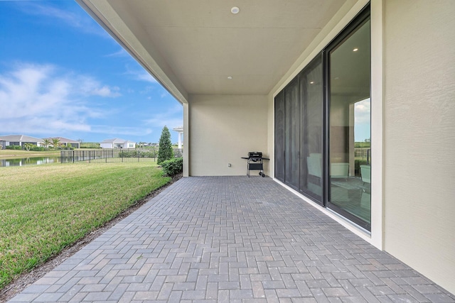 view of patio / terrace featuring a water view and a grill